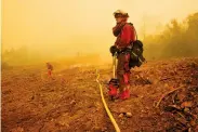  ?? Michael Macor / The Chronicle ?? Jeremy Roberson, an inmate firefighte­r, keeps an eye on hot spots Wednesday near Mariposa.