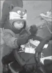  ?? JOEL RUBINOFF, RECORD STAFF ?? Two-year old Finnegan McDevitt checks out his candy supply during the parade..