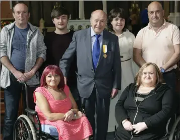  ??  ?? Michael Connolly, sacristan at the Holy Redeemer, with his family – Martin, Trisha, Wes, Abbie, Alison and Alan – after being presented with a Benemerent­i papal medal for his services to the Church.