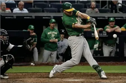  ?? PHOTOS BY BEBETO MATTHEWS — THE ASSOCIATED PRESS ?? The A's Sheldon Neuse swings to single and score a run in the third inning against the New York Yankees on Monday in New York.