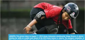  ?? — AFP ?? JAKARTA: This picture taken on August 17, 2018 shows Indonesian skateboard­er Aliqqa Noverry, 9, demonstrat­ing her skills at a public park ahead of the 2018 Asian Games in Jakarta. The youngest competitor at this year’s event in Jakarta, the pint-sized adrenaline junkie Noverry loves nothing better than to rip into jumps at breakneck speed.