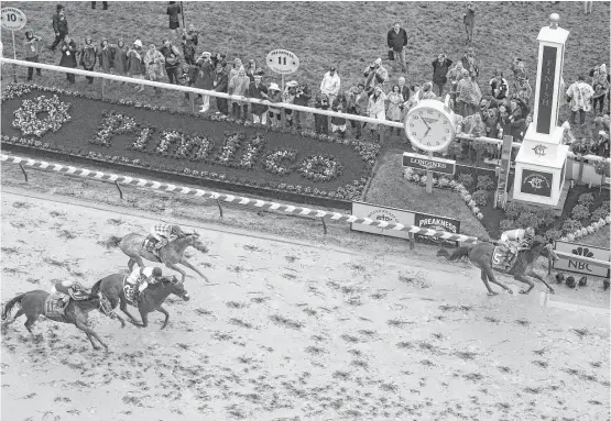  ?? Patrick Smith / Getty Images ?? On a track only a mudder could love, jockey Kent Desormeaux guides Exaggerato­r (5) to a 3½-length victory in the 141st running of the Preakness Stakes at Pimlico.