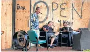  ?? Mike Stocker / South Florida Sun-Sentinel via AP ?? Florida residents who chose not to evacuate relax at a cigar lounge in Hallandale Beach, Fla.