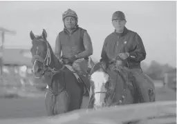  ?? JULIO CORTEZ/AP ?? Hall of Fame trainer D. Wayne Lukas, right, thinks filly Secret Oath, left, has what it takes to deliver him a record-tying seventh victory in the Preakness Stakes.