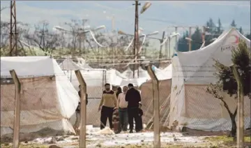  ?? Frederic Lafargue Afp/getty Images ?? SYRIANS WHO FLED the Idlib region gather at a camp set up by the Turkish army near Kavalcik. In Idlib province, Syrian government troops recently routed rebels who had for months occupied “liberated” territory.