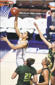  ?? Jessica Hill / Associated Press ?? UConn’s Gabby Williams makes a basket past South Florida’s Tamara Henshaw, from left, Maria Jespersen and Laura Ferreira Tuesday night in Uncasville.