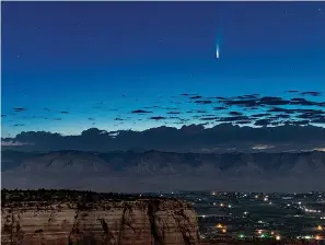  ?? Conrad Earnest via AP ?? ■ Comet Neowise soars in the horizon of the early morning sky Thursday in this view from the near the grand view lookout at the Colorado National Monument west of Grand Junction, Colo. The newly discovered comet is streaking past Earth, providing a celestial nighttime show after buzzing the sun and expanding its tail.