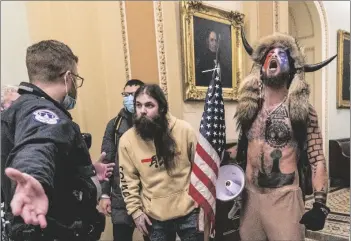  ?? BALCE CENETA, FILE
AP PHOTO/MANUEL ?? Supporters of President Donald Trump, including Jacob Chansley (right with fur hat) are confronted by U.S. Capitol Police officers outside the Senate chamber inside the Capitol during the capitol riot in Washington, Jan. 6.