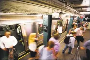  ?? Michael Nagle / Bloomberg ?? Commuters exit a train at the Wall Street subway station near the New York Stock Exchange in New York on Monday.