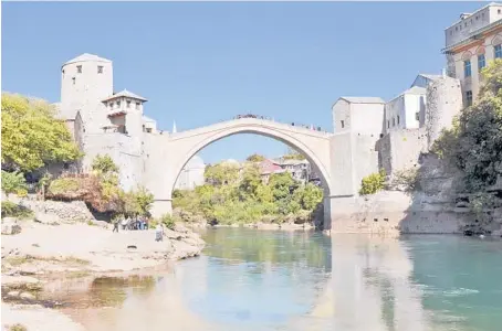  ?? RICK STEVES ?? The Bosnian city of Mostar and its famous bridge, which was rebuilt after being destroyed in the Yugoslav Wars of the 1990s.