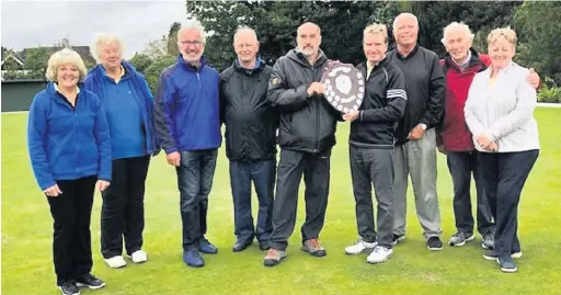  ??  ?? ●●Kevin Wilson presenting the Mixed Knockout shield at Queensgate to Wilmslow BC A team after their victory.