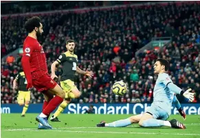  ?? GETTY IMAGES ?? Mo Salah beats goalkeeper Alex McCarthy to scores Liverpool’s third goal in their 4-0 win over Southampto­n.