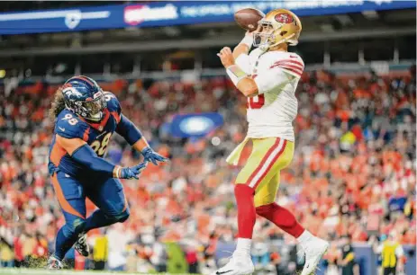  ?? Jack Dempsey/Associated Press ?? Jimmy Garoppolo steps out of bounds for a safety while under pressure from Denver defensive tackle Mike Purcell on Sept. 25.