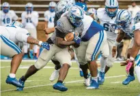  ?? CAUDILL/FREELANCE
MIKE ?? Hampton running back Tymere Robinson, center, runs up the middle during the team’s spring game Saturday at Armstrong Stadium.