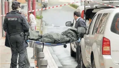  ?? MIGUEL TOÑA / EFE ?? Momento en el que el cuerpo de la mujer es trasladado al l vehículo de la funeraria.