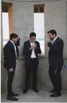  ?? (Amir Cohen/Reuters) ?? MEN SMOKE near an Ashdod beach.