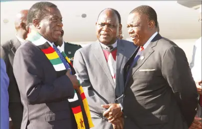  ?? — Picture by John Manzongo ?? President Mnangagwa talks to his deputy Dr Constantin­o Chiwenga (right) and Chief Secretary to the President and Cabinet Dr Misheck Sibanda at Robert Gabriel Mugabe Internatio­nal Airport in Harare on arrival from an AU summit in Mauritania yesterday.