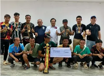  ?? — Ukas photo ?? Dr Jerip (standing, fifth left) and others pose for a group photo with the champions of the Biannah Cup football competitio­n.