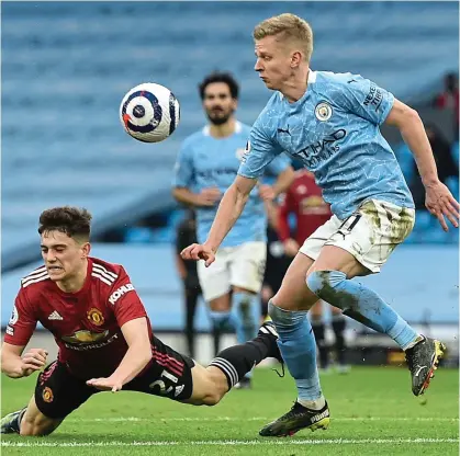  ?? PICTURE: REUTERS ?? Eyes on the prize: Zinchenko remains focused as United’s Daniel James takes a tumble