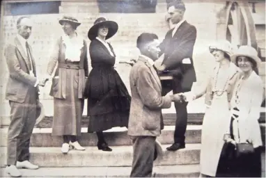  ?? COURTESY OF THE BURN FAMILY ?? Harry Burn shakes hands with Anita Pollitzer of the National Woman’s Party on Aug. 19, 1920, one day after he cast his vote in favor of suffrage, making Tennessee the 36th state to ratify the 19th Amendment.
