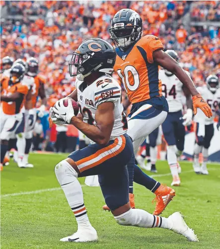  ?? Eric Lutzens, The Denver Post ?? Bears cornerback Kyle Fuller intercepts the ball during the fourth quarter Sunday.