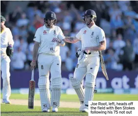  ??  ?? Joe Root, left, heads off the field with Ben Stokes following his 75 not out