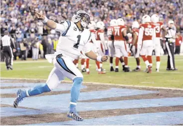  ?? Chuck Burton / Associated Press ?? Panthers quarterbac­k Cam Newton celebrates after scoring on one of his two touchdown runs Sunday.