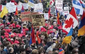  ?? JUSTIN TANG, THE CANADIAN PRESS ?? Members of the Armenian community and human rights activists gather on Parliament Hill to commemorat­e the centennial of the Armenian Genocide on Friday.