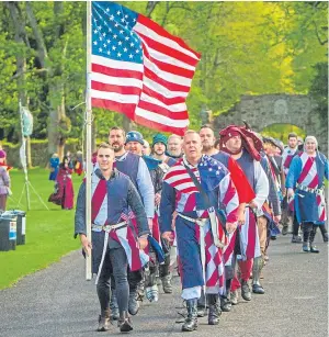  ??  ?? Team members from the US proudly hold their flag aloft.