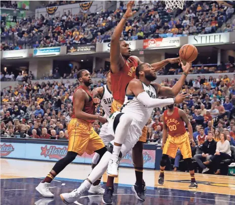  ?? BRIAN SPURLOCK / USA TODAY SPORTS ?? Bucks center Greg Monroe slips past Pacers forward Kevin Seraphin and gets off a shot. Monroe had just two points and four rebounds in 18 minutes.