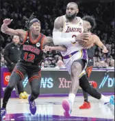  ?? The Associated Press Marcio Jose Sanchez ?? Lakers forward Lebron James drives against Bulls guard Ayo Dosunmu in the second half of Chicago’s 118-108 victory Sunday at Crypto.com Arena.
