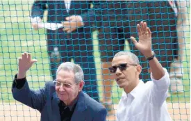  ?? (AP FOTO) ?? UNDER TRUMP ADMINISTRA­TION. President Barack Obama (right) and his Cuban counterpar­t Raul Castro wave to cheering fans as they arrive for a baseball game between the Tampa Bay Rays and the Cuban national baseball team, in Havana, Cuba in this file...