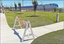  ?? SEAN D. ELLIOT/THE DAY ?? Workers put the finishing touches on the new town park Thursday at the corner of Main Street and Pennsylvan­ia Avenue in Niantic.