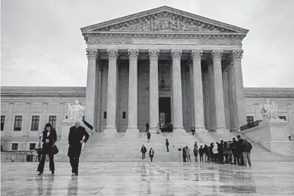  ?? AP Photo/J. Scott Applewhite ?? People stand Tuesday on the plaza of the Supreme Court in Washington to attend arguments. The Supreme Court is taking up a case involving the search of a rental car that lawyers say has the potential to affect the 115 million annual car rentals in the...