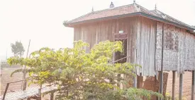  ??  ?? Top: Seamstress­es at work in Kampong Cham, Cambodia and a typical home in the provinces.