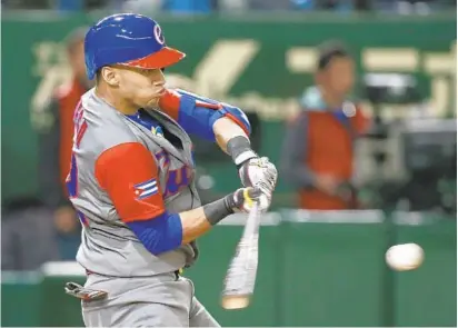  ?? SHIZUO KAMBAYASHI/ASSOCIATED PRESS ?? Cuba outfielder Victor Victor Mesa, 21, singles at the World Baseball Classic in March 2017. Playing in the Cuban National Series league in 2016-17, Mesa hit .354/. 399/. 539 in 70 games. He stole 40 bases and had more extra-base hits (27) than strikeouts (19).