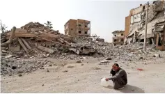  ??  ?? Photo shows Abd al-Ibrahim, whose home was destroyed during fighting, as he rests on his trip to supply water to his family at the house they are squatting in Raqa.