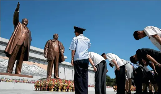  ?? AP ?? People pay their respects in front of bronze statues of the late leaders Kim Il Sung, left, and Kim Jong Il at Munsu Hill in Pyongyang, as North Korea marked the anniversar­y of Kim Il Sung’s death yesterday.