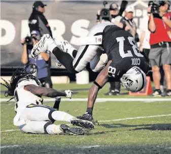  ?? Carlos Avila Gonzalez / The Chronicle ?? Raiders tight end Jared Cook (87) is upended after a 31-yard gain in the final minute of the third period. It was Oakland’s second of three red-zone trips, none of which resulted in a touchdown.