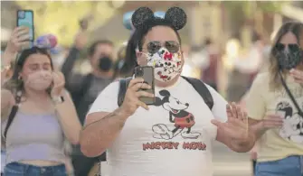  ?? JAE C. HONG/AP FILE ?? Guests at Disneyland on April 30, the day the Anaheim, California, park reopened.