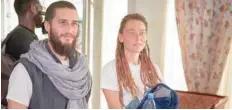  ?? — AFP ?? Italian Luca Tacchetto and Canadian Tedith Blais are greeted by officials as they arrive at the airport in Bamako on Saturday, after their release by UN peacekeepe­rs.