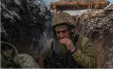  ?? ?? A Ukrainian soldier of the 41st brigade walks in a trench near the frontline, outside Kupiansk, Kharkiv region.