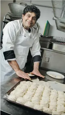  ?? PHOTOS: CHRIS MIKULA / OTTAWA CITIZEN ?? Thomas Thottungal of Coconut Lagoon prepares fresh bread in the kitchen. The restaurant’s layered flatbread melts in your mouth.