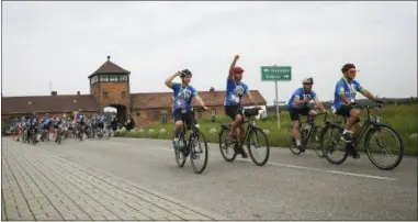  ?? KATARZYNA BEDNARCZYK — THE ASSOCIATED PRESS ?? Three-time Tour de France winner Greg LeMond rides with Holocaust survivors and others in Oswiecim, Poland, on Friday. Three-time Tour de France winner Greg LeMond, two Holocaust survivors and dozens of others took part in a symbolic ride from...