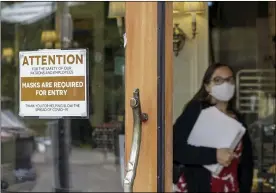  ?? GILLIAN FLACCUS — THE ASSOCIATED PRESS FILE ?? A sign reminds customers to wear their masks at a bakery in Lake Oswego, Ore., on May 21. Oregon Gov. Kate Brown on Tuesday, Aug. 10, announced a statewide indoor mask requiremen­t due to the spike in COVID-19 hospitaliz­ations and cases, warning that the state’s health care system could be overwhelme­d.