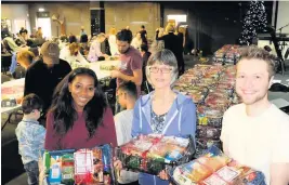  ??  ?? Packing up hampers for the homeless - from left, volunteers Mwaka Smallridge, Julia Turner and Mike Owen