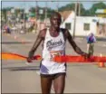  ?? BARRY BOOHER — THE NEWS-HERALD ?? Kiprop Mutai breaks the tape to win the men’s race July 8 during the Johnnycake Jog.
