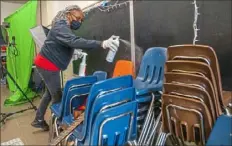  ?? Andrew Rush/Post-Gazette ?? Latisha Bledsoe prepares for the return of students in the music room at Manchester Academic Charter School in Manchester.