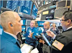  ??  ?? Traders at the New York Stock Exchange, above, which has witnessed a lengthy bull run