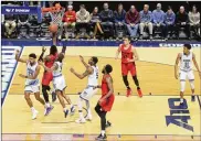  ?? DAVID JABLONSKI/STAFF ?? Dayton’s Dwayne Cohill scores in the Flyers’ blowout of Rhode Island on Saturday at the Ryan Center in Kingston, Rhode Island.